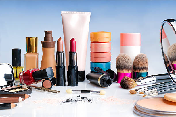 Makeup collection with lipsticks, foundation, powders and brushes
