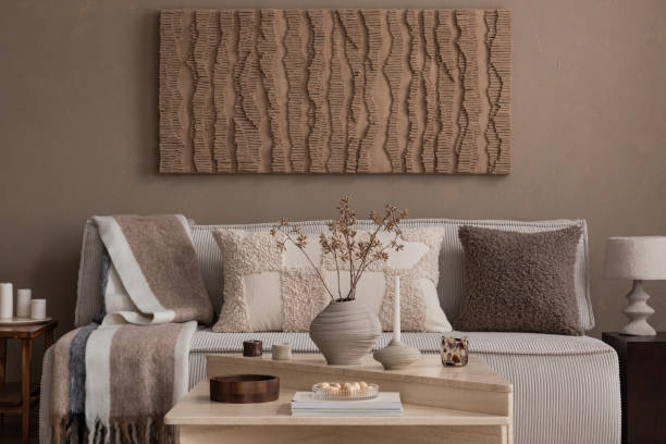 Neutral living room with a sofa, textured cushions, a throw and a coffee table